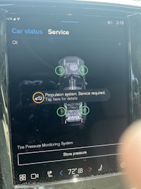 a screen showing a car with a service button on it