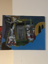 an abstract painting hanging on a wall