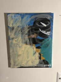 an abstract painting hanging on a wall